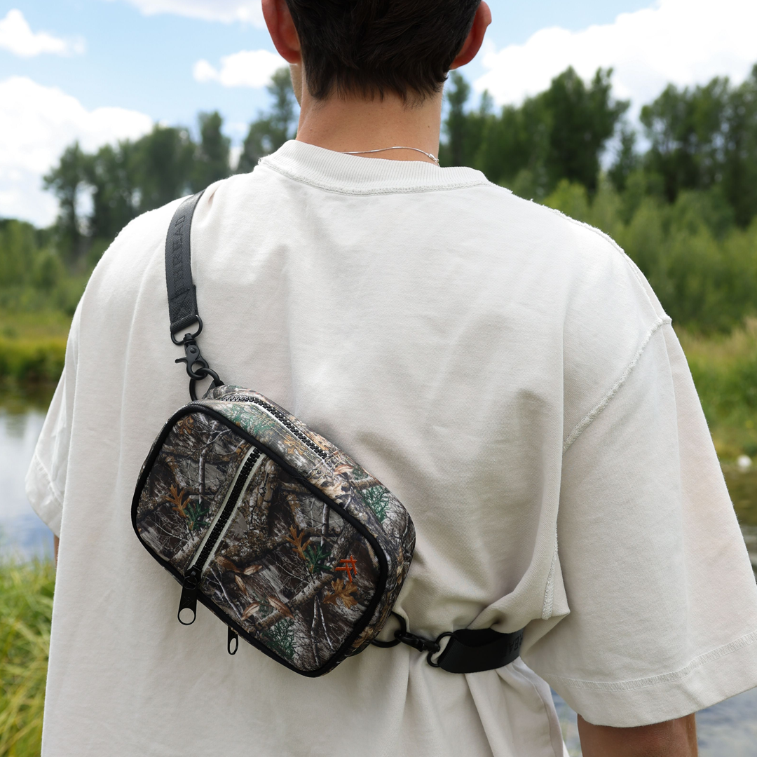 Person wearing the Thread® Realtree Edge crossbody bag across the chest