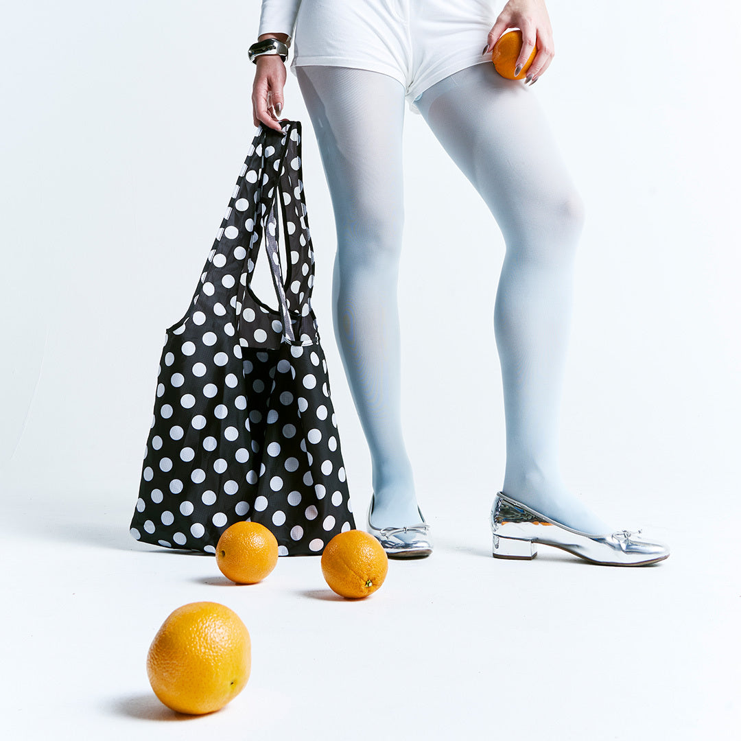 Woman holding a Packable Tote Bag - Polka Dot - Thread®